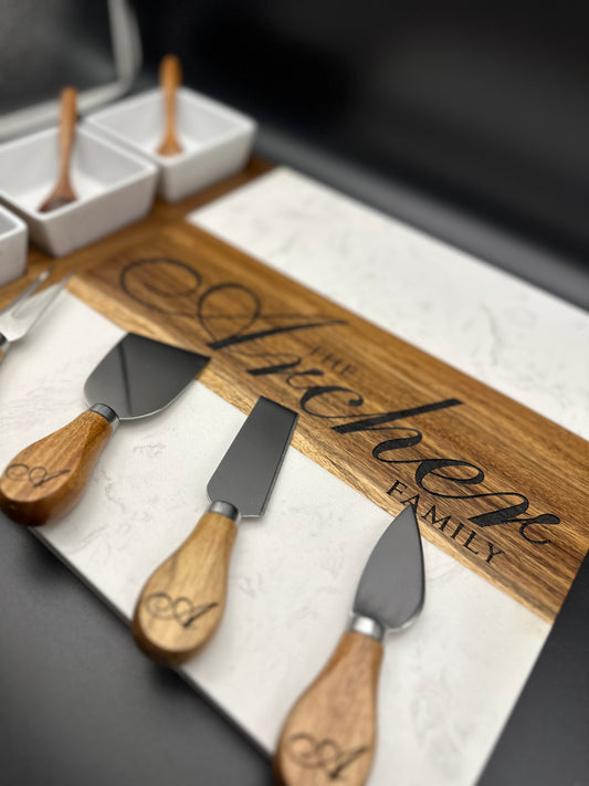 Custom engraved cheese board set with bowls, spoons, and utensils