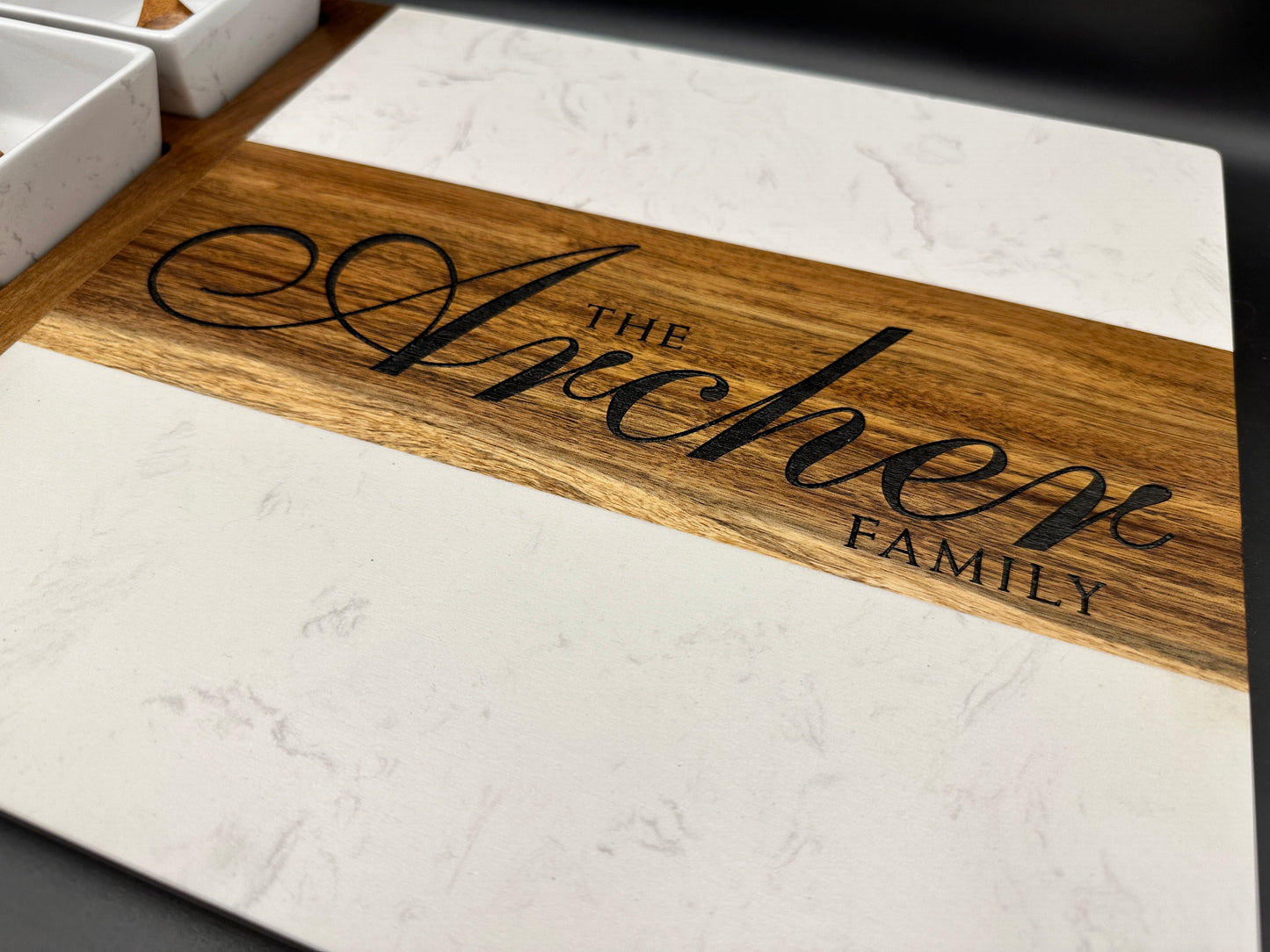 Marble and Acacia wooden cutting board with engraved 'The Arichene Family' on wooden surface