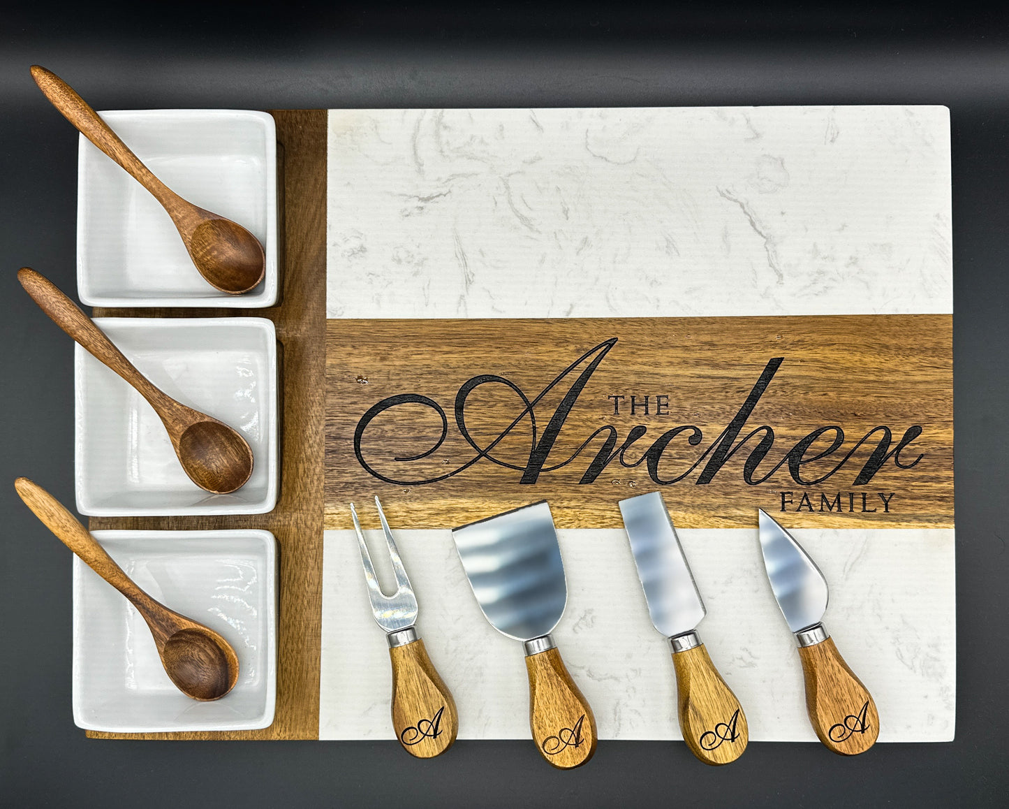 Personalized marble and acacia charcuterie board engraved with family name