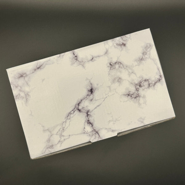 Marble-patterned gift box on a dark background