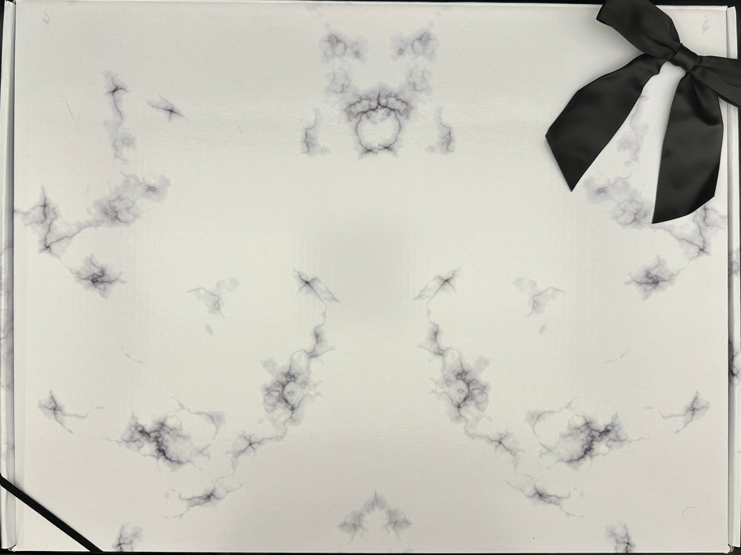 Gift box with marble pattern and black ribbon