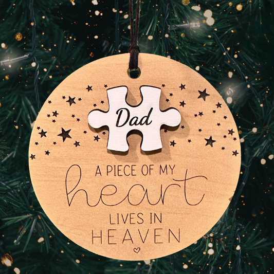 Round ornament featuring the phrase "A Piece of My Heart Lives in Heaven" along with a white puzzle piece featuring your loved one's name or nickname.