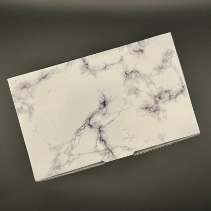 Marble-patterned gift box on a dark background